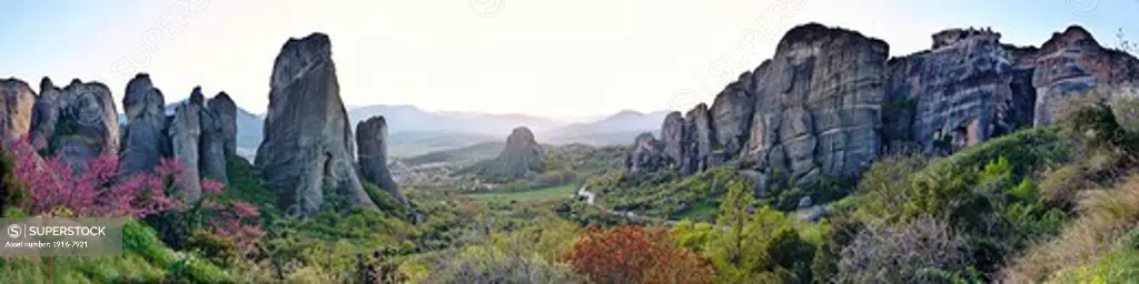 Greece, Kastraki, Sunset over sandstone rock pillars in Meteora, Holy Monastery of St. Nicholas Anapausas on middle and Holy Monastery of Varlaam on right