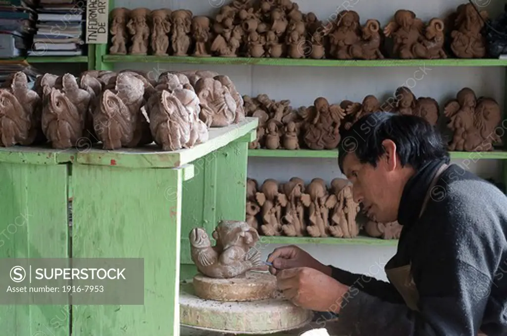 Peru, Ayacucho, handicraft.  Aristides Quispe at work in his laboratory.