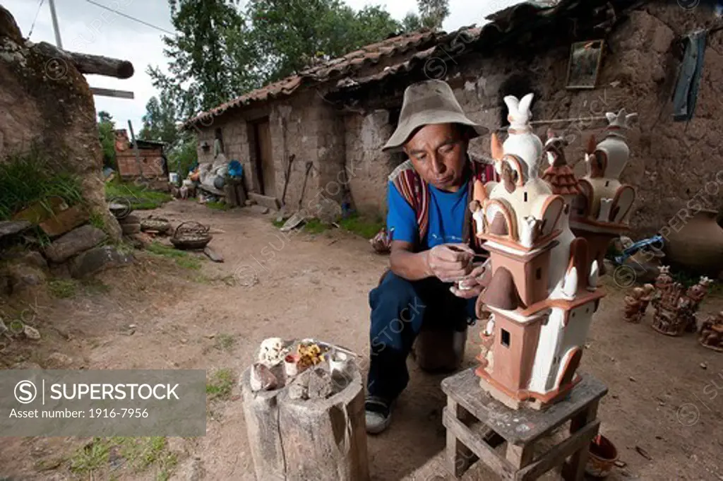 Peru, Ayacucho, handicraft ..Eloy Yupanqui working outside his house in the countryside of Quinoa