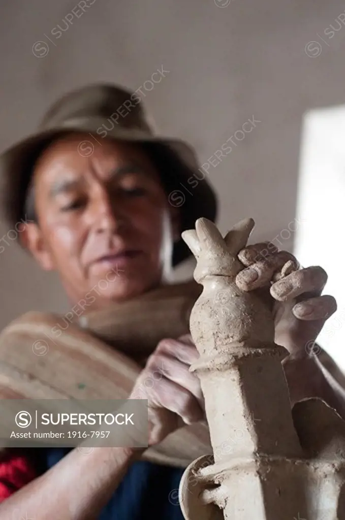Peru, Ayacucho, handicraft. .Eloy Yupanqui working in his workshop in Quinoa