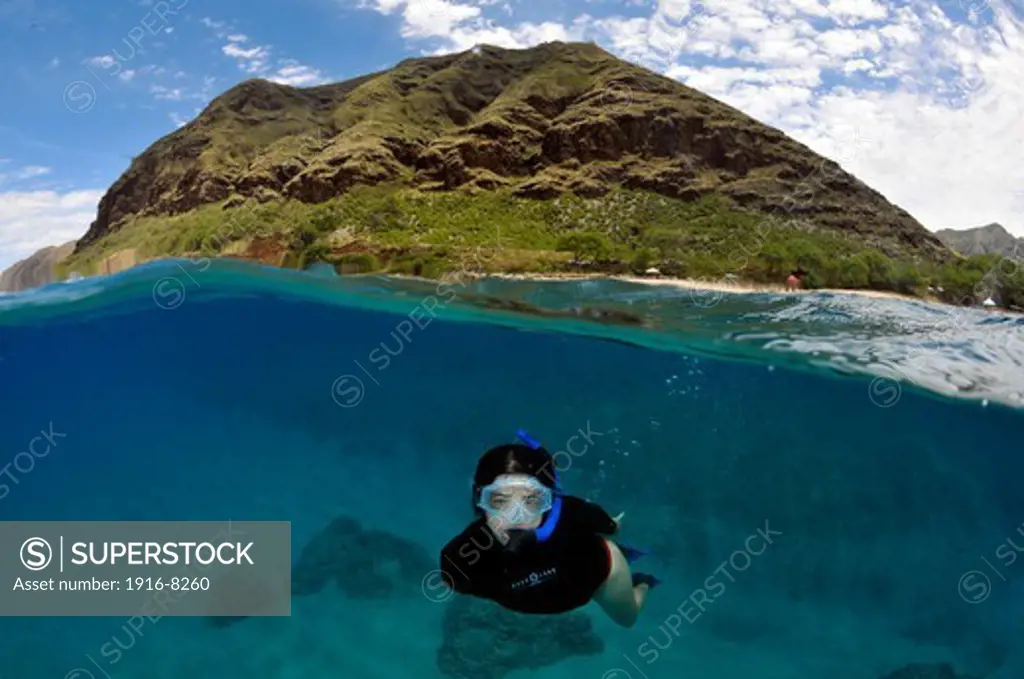 Split image of snorkeler and costal hill, Makua Beach, Oahu, Hawaii, USA