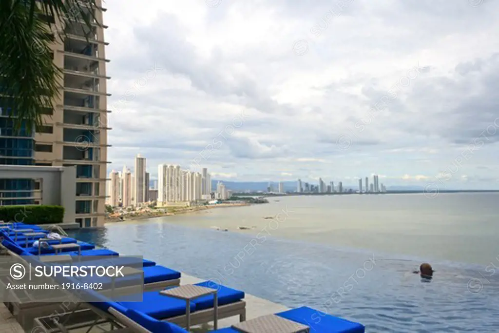 View from the pool of the Trump Ocean Club International Hotel in Panama with a man swimming.