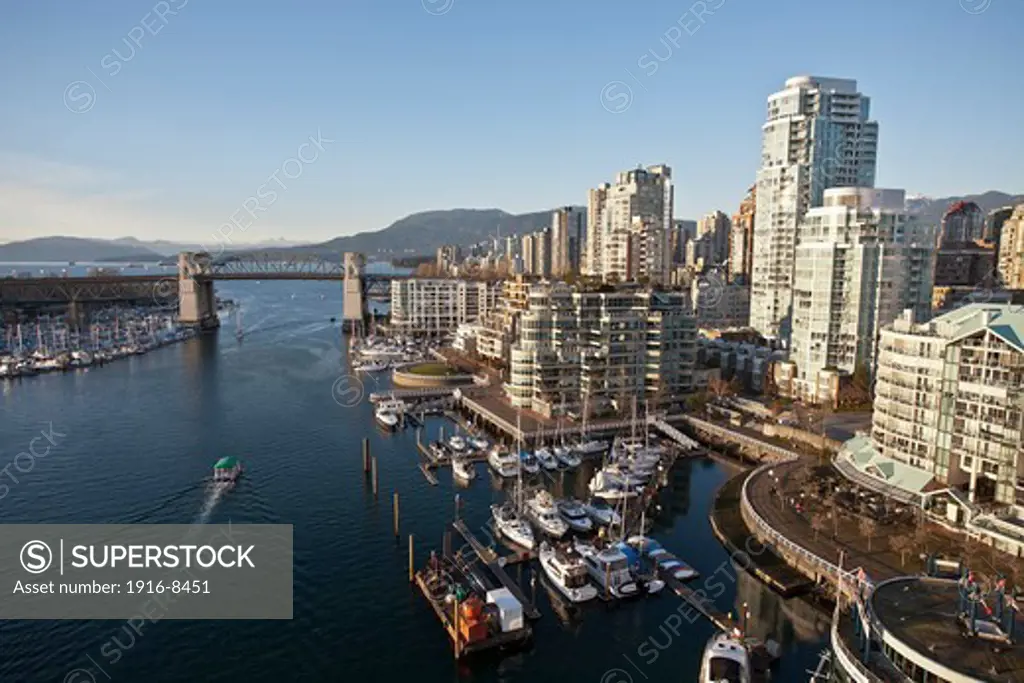 Yaletown neighborhood and the false creek viewed from the Granville Bridge. English Bay and the Burrard Britge at the backgroung. Vancouver, British Columbia, Canada