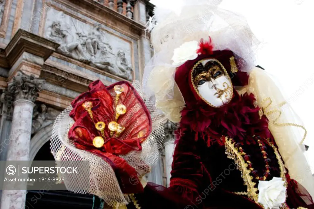 People dressed for the Carnival in Venice Italy.  Carnival or Carnevale in Italian, is a celebration for the 10 days before Lent, the Christian time of fasting before Easter Sunday.  People come from all over the globe to participate in the celebration that is centered in Piazza San Marco.  They dress in elaborate costumes with masks.  There are performaces of the Commedia dell'arte as well as parades throughout the city.