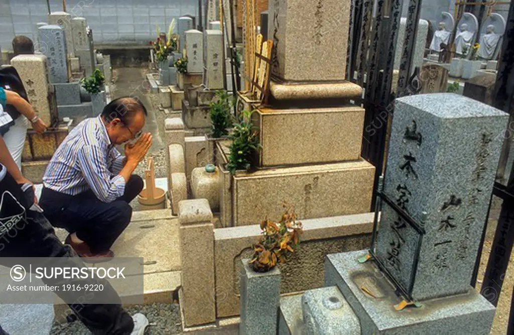 Praying at the Cemetery near the Nishiki Tenman-gu chapel,Kyoto, Japan