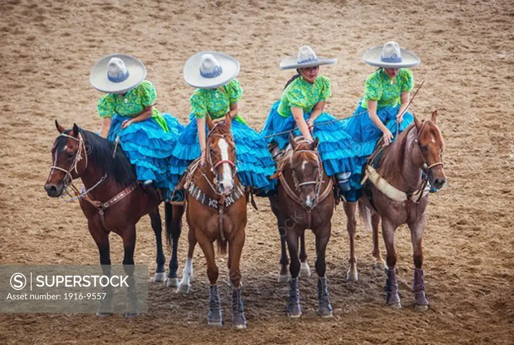Escaramuzas ride their horses. A charreada Mexican rodeo at the Lienzo Charro Zermeno, Guadalajara, Jalisco, Mexico