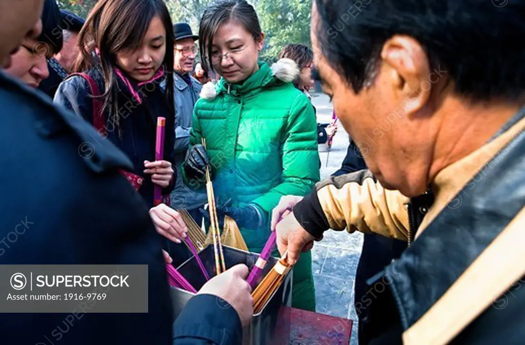 Believers burning incense at Yong he Gong lama temple,Beijing, China