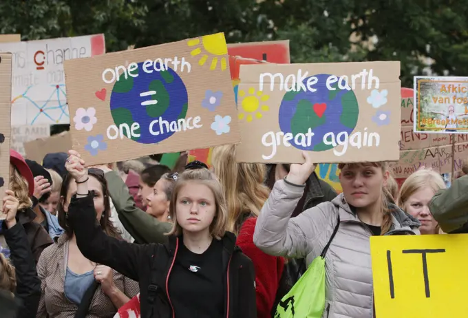 School students and activists gather during a climate strike march on September 27, 2019 in The Hague,Netherlands.  Activists and students  joined together in The Hague against the Dutch governments lack of action in the face of the climate crisis. According to Fridays for Future Nederland, 'The current climate agreement is not enough and its not in accordance with the Urgenda verdict, demand a Dutch Green New Deal with fair and ambitious climate policy to tackle the climate crisis effectively
