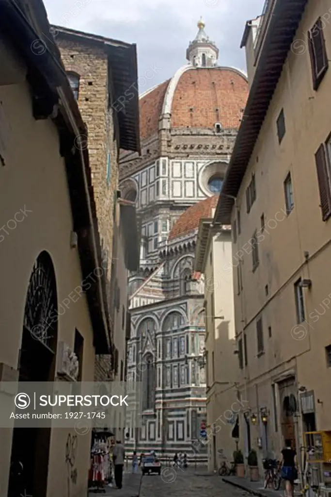 Duomo cathedral looms over the narrow streets of Florence  Italy