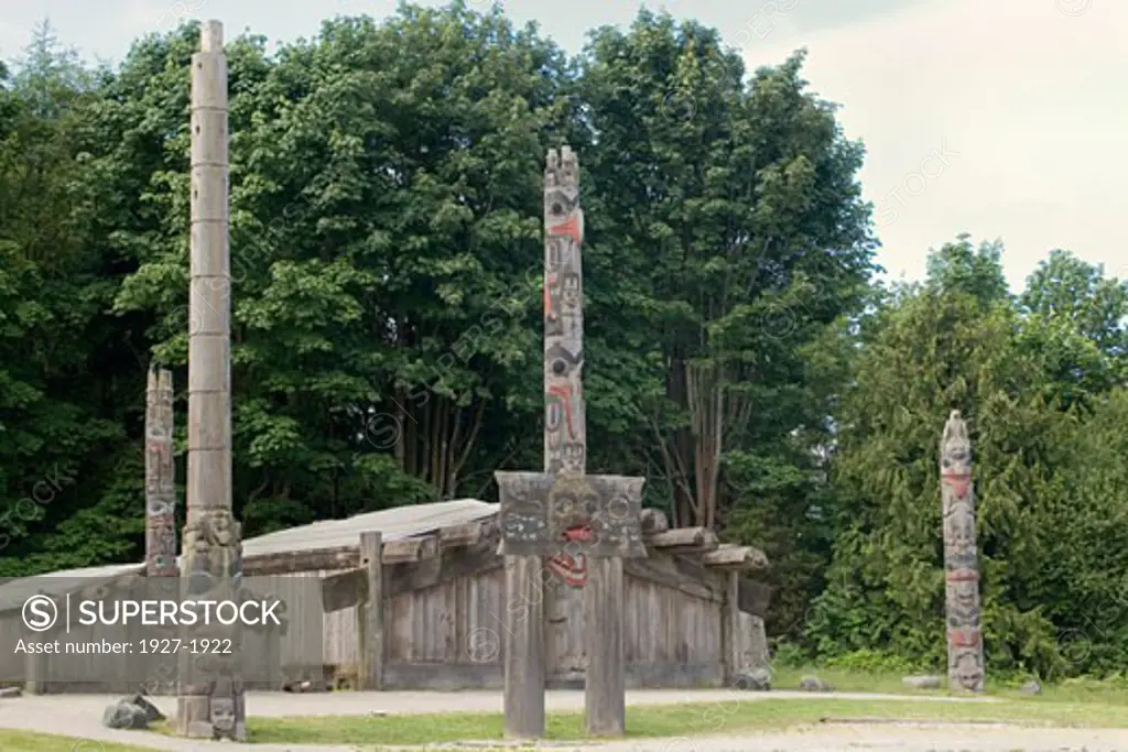 Totem Poles and Haida Long House replica on the grounds of the Museum of Anthropology Vancouver  Canada