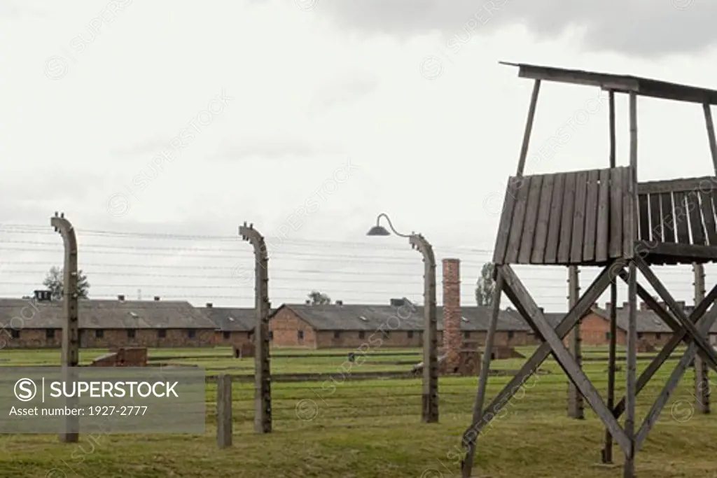 Guard tower electrified fence and prisobner barracks in the Birkenau Death Camp Auschwitz Poland