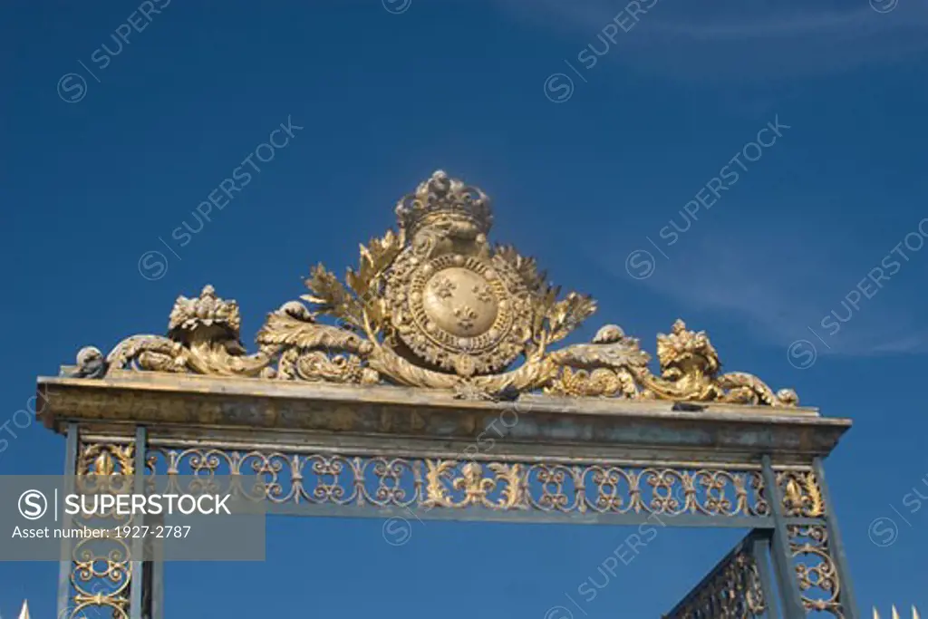 Main entrance gate to the Palace of Versailles shown the fleur dlys Versailles France