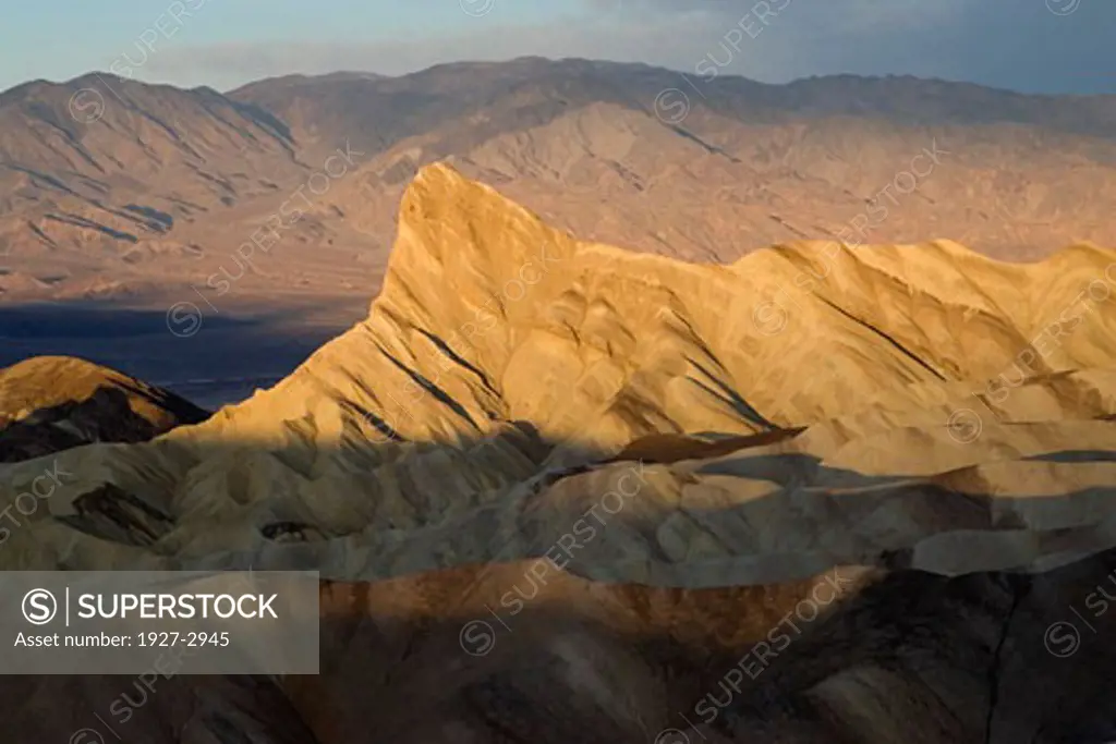 Sunrise at Zabrislie Point lights the rock formation called Manly Beacon Death Valley National Park California