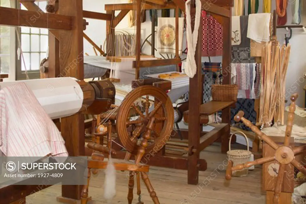 Weaver's Shop with spinning wheel and loom.Colonial Williamsburg,Virginia