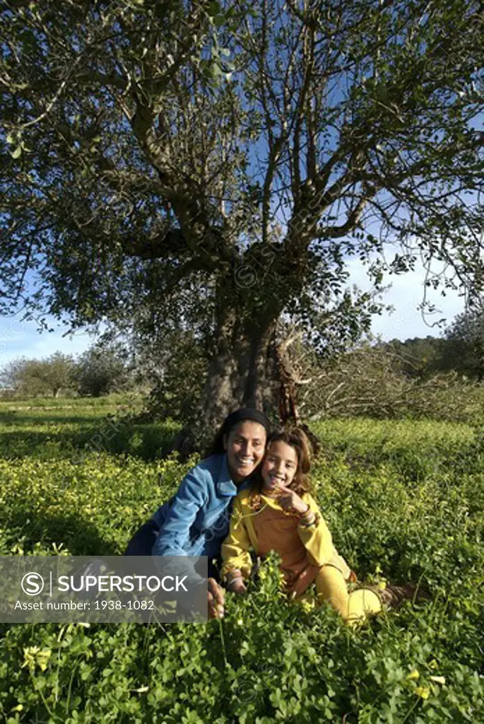 Mother and daughter under a tree San Carlos Ibiza Spain