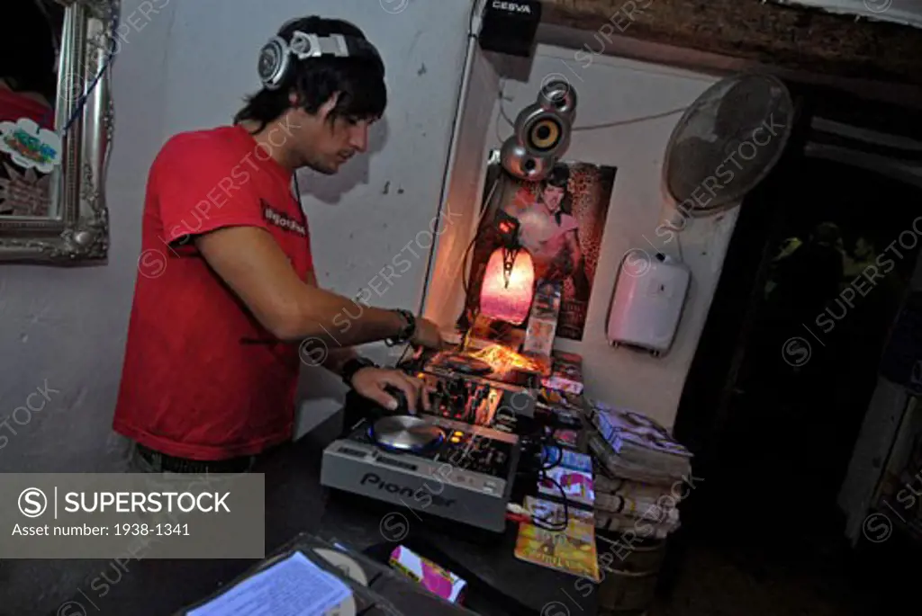 DJ playing inside of Base bar  in La Marina  Ibiza