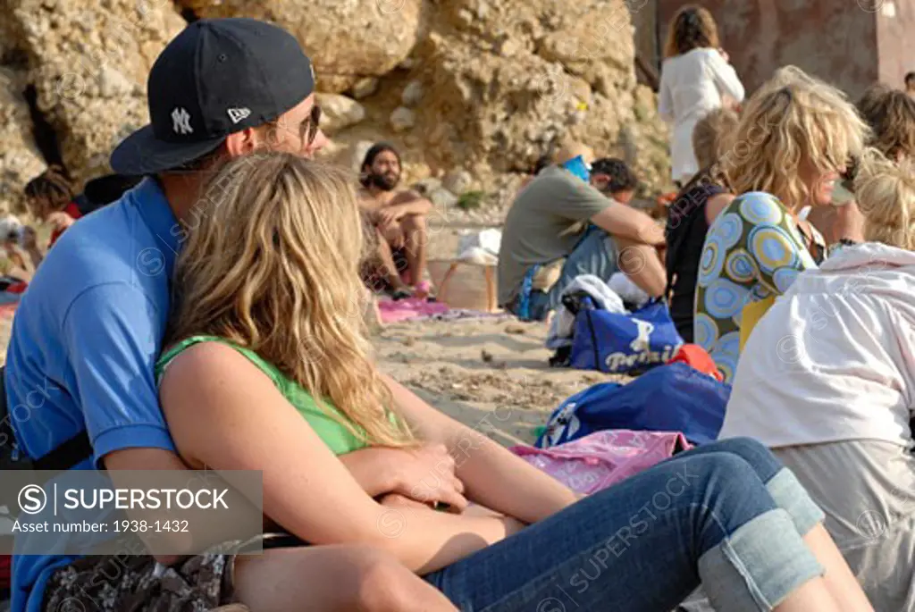 People enjoying sundays in popular Benirras beach  where drum players play until sunset  Ibiza  Spain