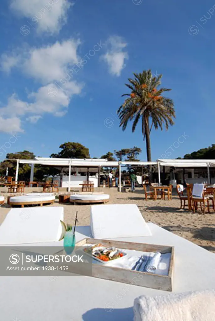 Tray with oysters and a fruit juice on a bed in Blue Marlin beach restaurant Ibiza Spain