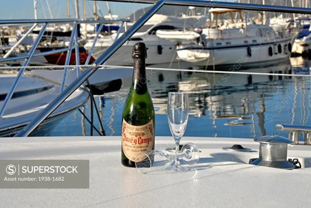Cava bottle and two cups on the front side of a luxurious yacht in Ibiza Spain