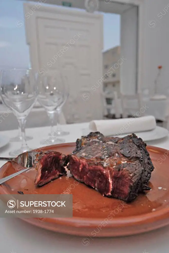 Thick beef meat cooked on a grill at a restaurant