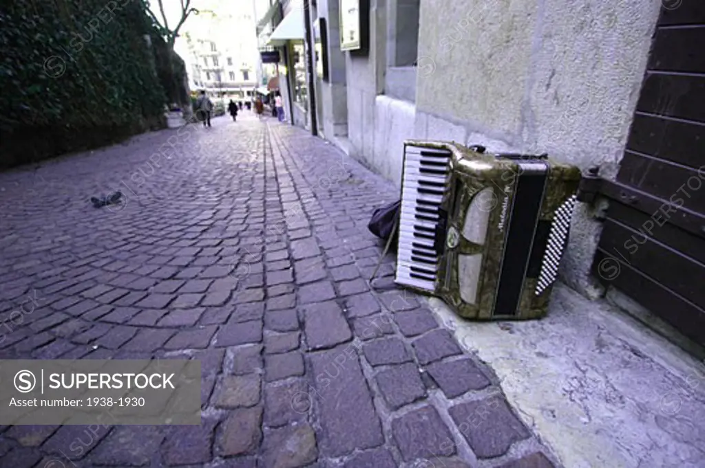 Accordion left on a stone street of Geneva  Switzerland