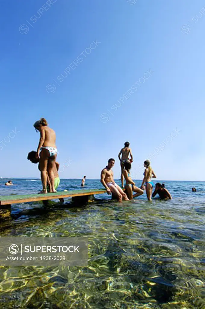Young people taking a bath in Las Salinas beach in Ibiza Balearic Islands Spain  Nano Calvo VisualWritten VWPics com