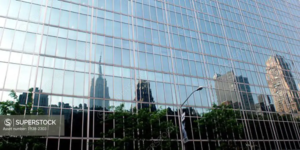 Buildings and skyscrapers reflected in the windows of another building  in Manhattan  New York City