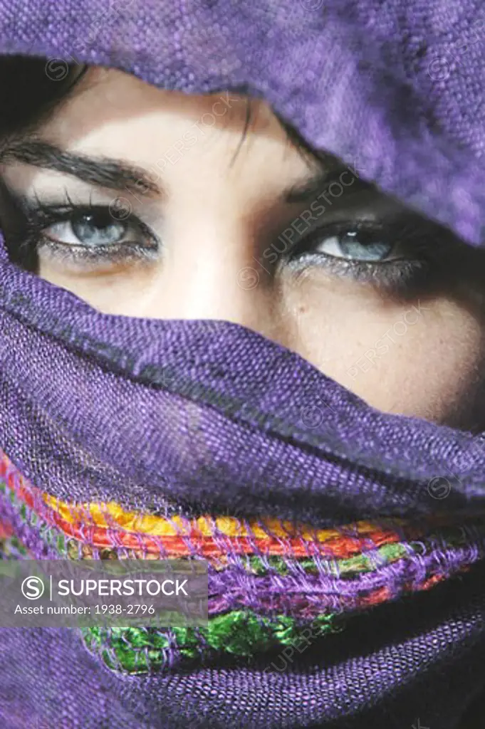 Model Released Attractive young  woman with clear blue eyes with her face covered
