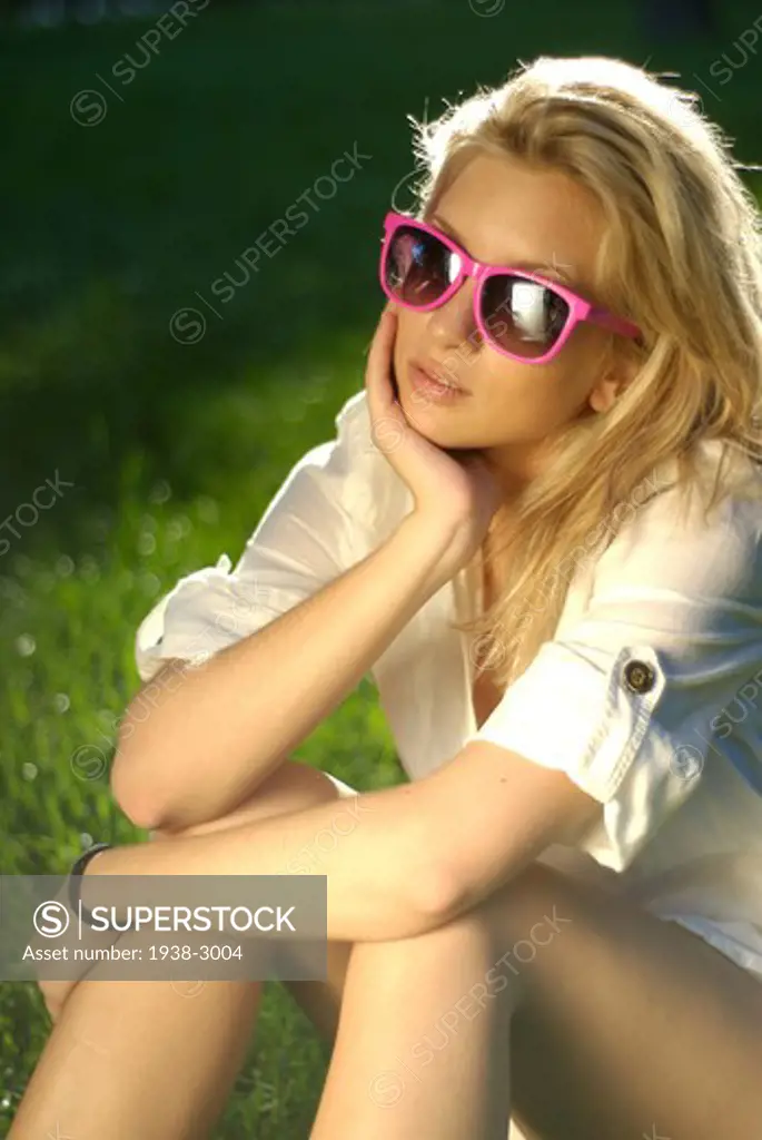 Spain, Madrid, Outdoor portrait of young blonde woman wearing pink sunglasses