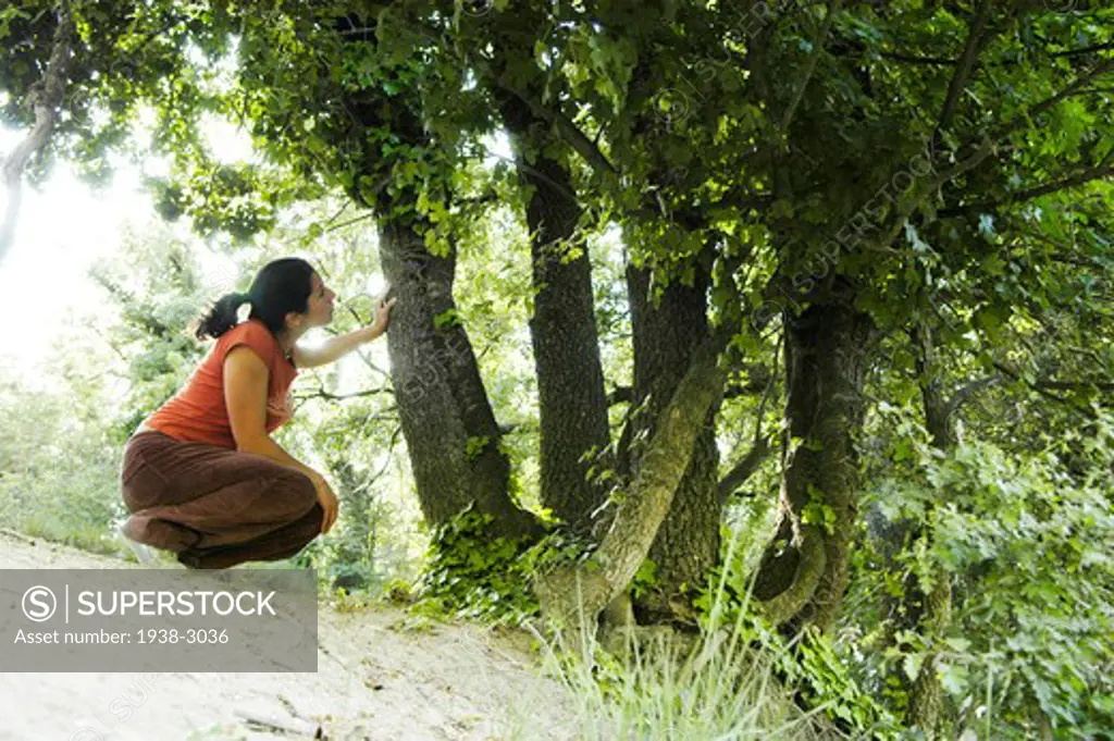Spain, Barcelona, Young woman relaxing in nature