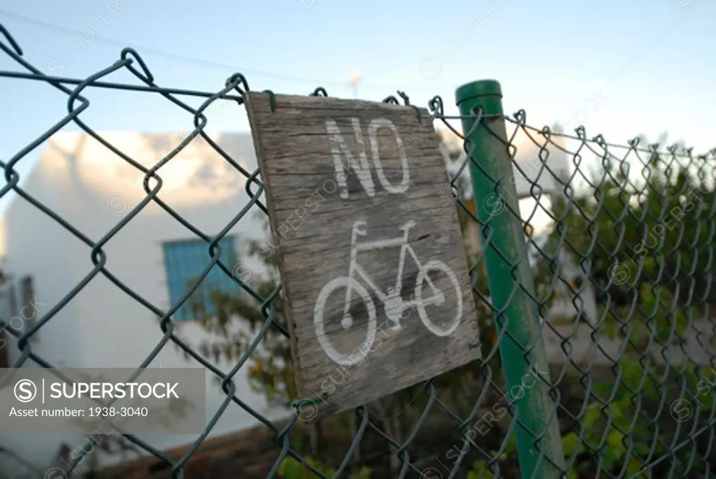No Bicycle sign on a chainlink fence, La Mola, Formentera Island, Balearic Islands, Spain