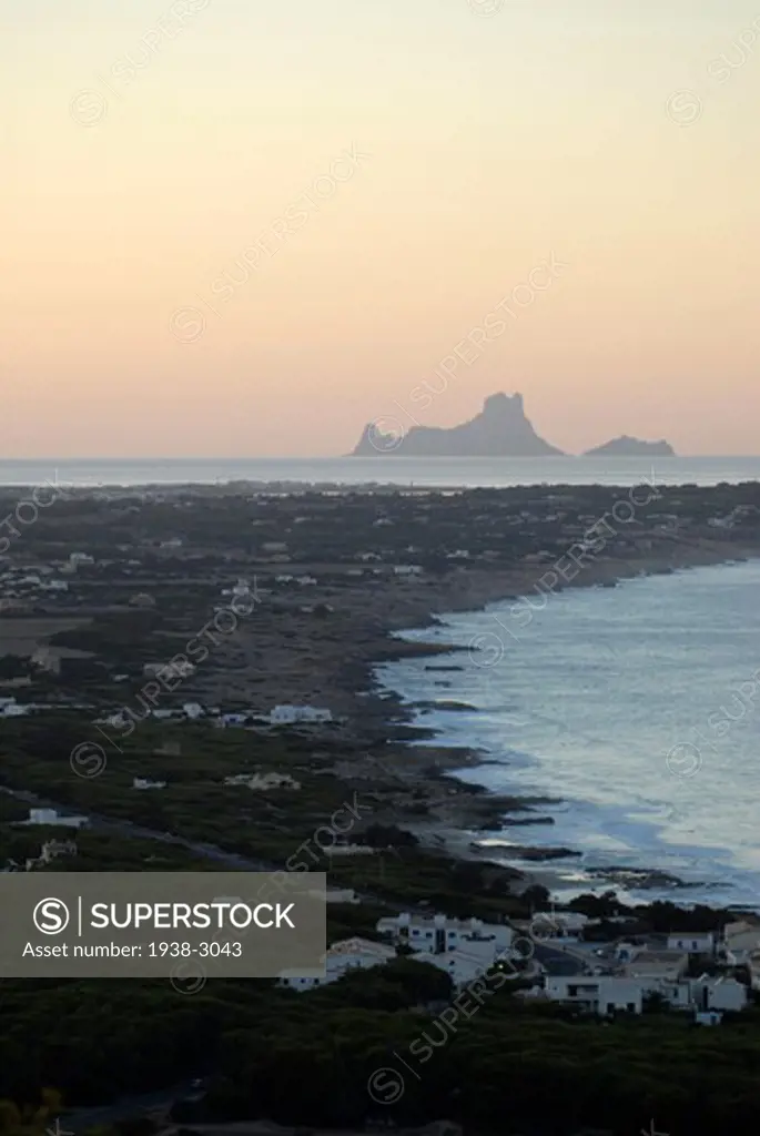 Sunset over the sea with Es Vedra in the background viewed from La Mola, Formentera Island, Balearic islands, Spain