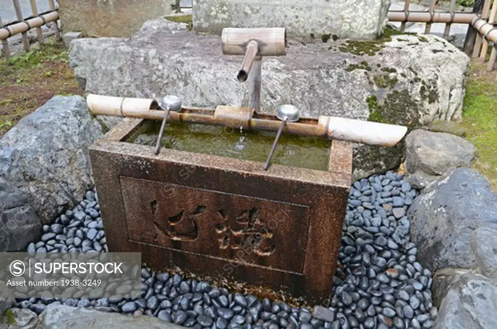Japanese fountain with ladles at Tenryu-ji Temple, Arashiyama, Kyoto Prefecture, Honshu, Japan