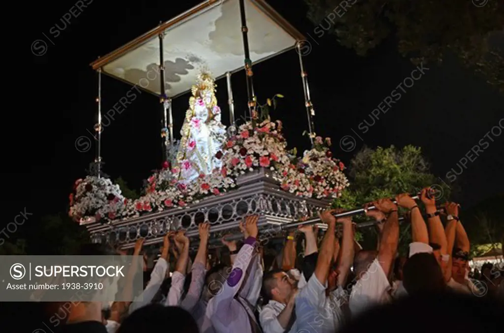 Volunteers carry the heavy shrine during El Rocio Pilgrimage (Romeria de el Rocio) in Getafe, South of Madrid. The event congregates thousands of migrants that live in the area but are related to the community of Andalucí­a, home of the original Romeria de el Rocio.