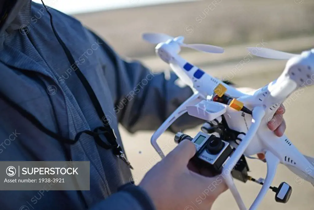 Young man flying Phantom Drone outdoors