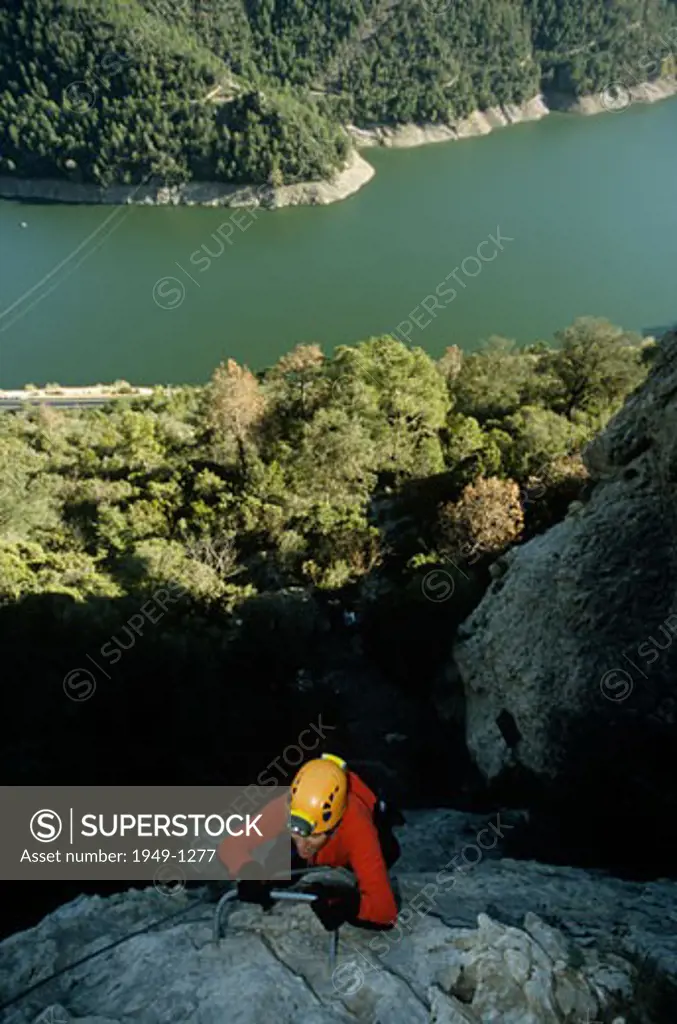 Climber at Regina via ferrata first part At the background Oliana dam