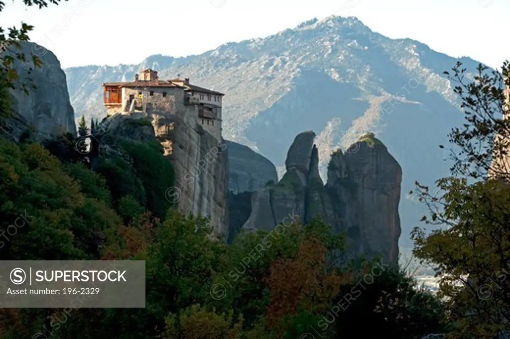 Greece, Thessalia, Meteora, Dramatic landscape with monastery on top of rock