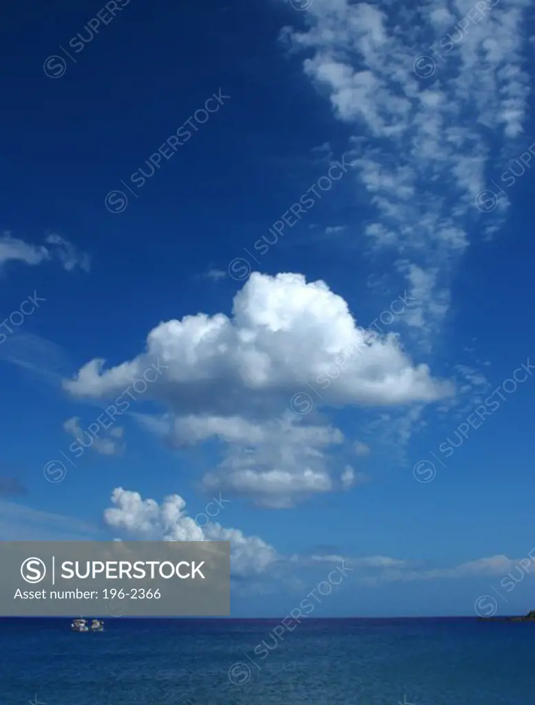 Greece, Cyclades, Tinos Island, Seascape with blue sky and white clouds