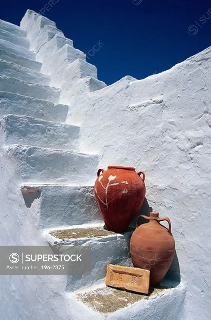 Greece, Cyclades, Tinos Island, Two jugs on old white steps