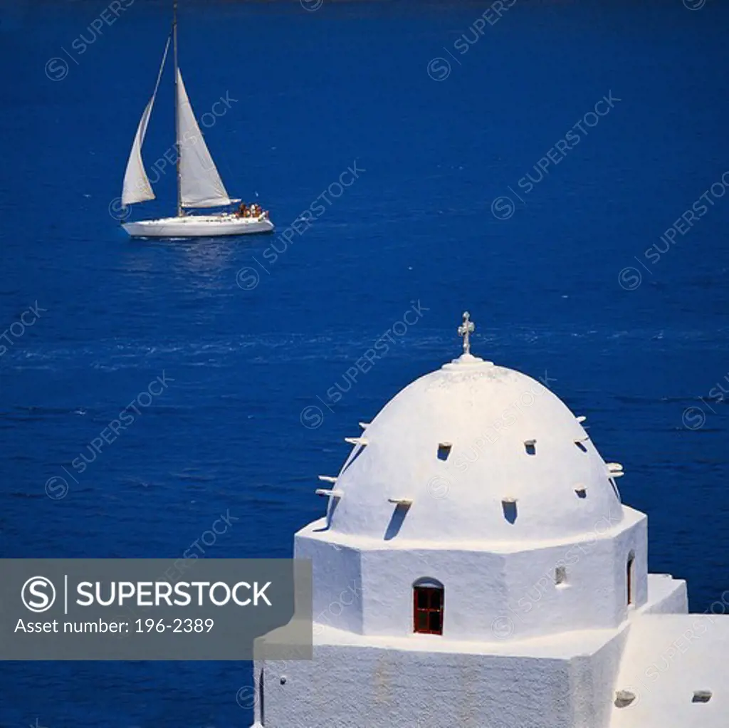 Greece, Cyclades, Ios Island, Sailboat passing church dome