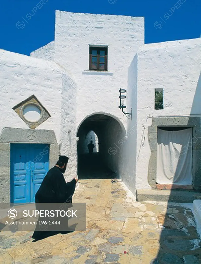 Greece, Dodecanese, Patmos Island, Priest walking through village