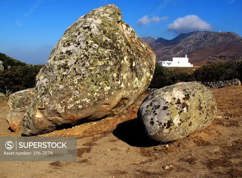 Greece, Cyclades, Tinos island, Large rocks, church in background