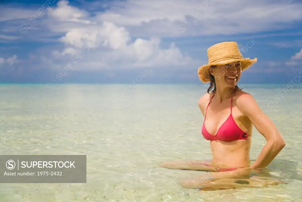 Woman in shallow water on the beach, Tahaa, Tahiti, French Polynesia