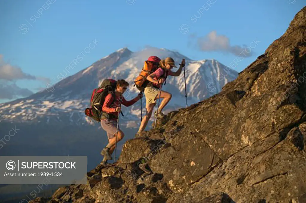 A couple hiking up a mountain ridge near Mount Adams