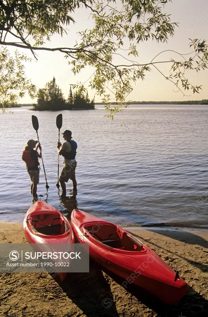 Couple with Kayaks, Otter Falls, Whiteshell Provincial Park, Manitoba, Canada.