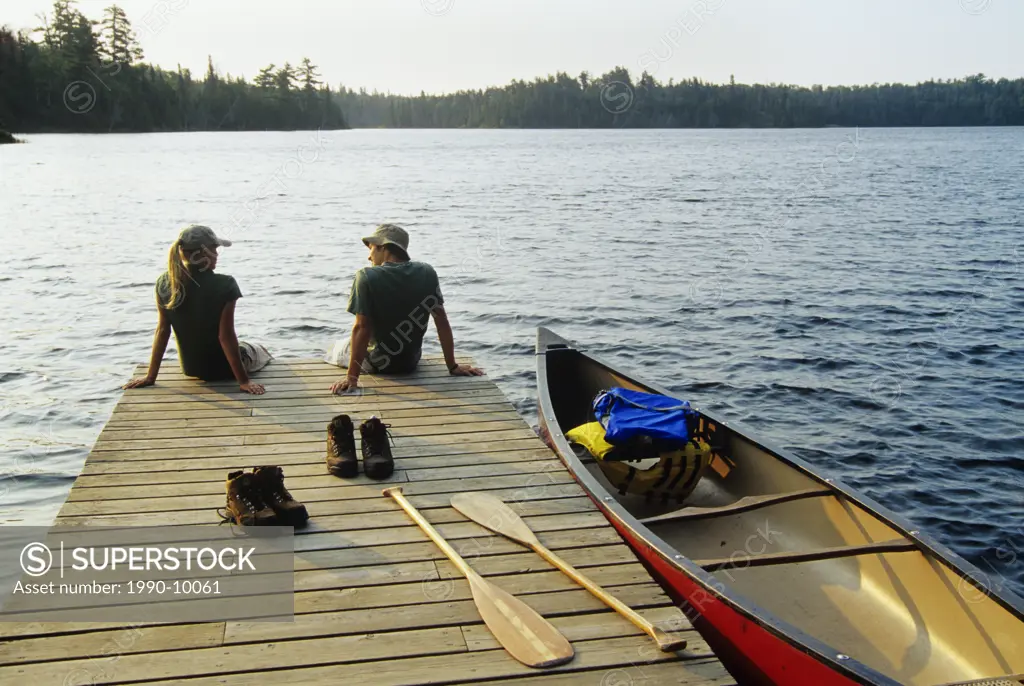 Teenagers on dock, Lyons Lakes, Whiteshell Provincial Park, Manitoba, Canada.