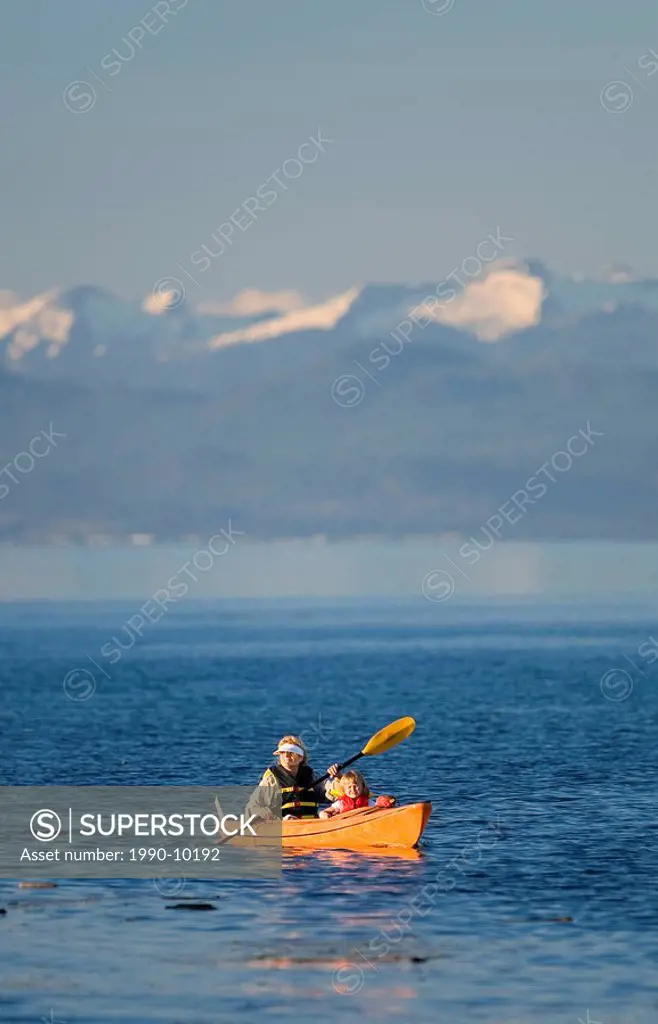 Mother and Daughter in kayak off of Goose Spit in Comox. Vancouver Island, British Columbia, Canada.