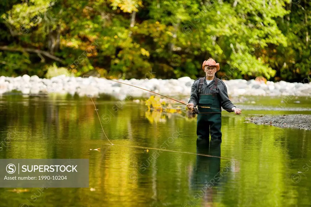 Man fly fishing, Oyster River. Courtenay, Vancouver Island, British Columbia, Canada