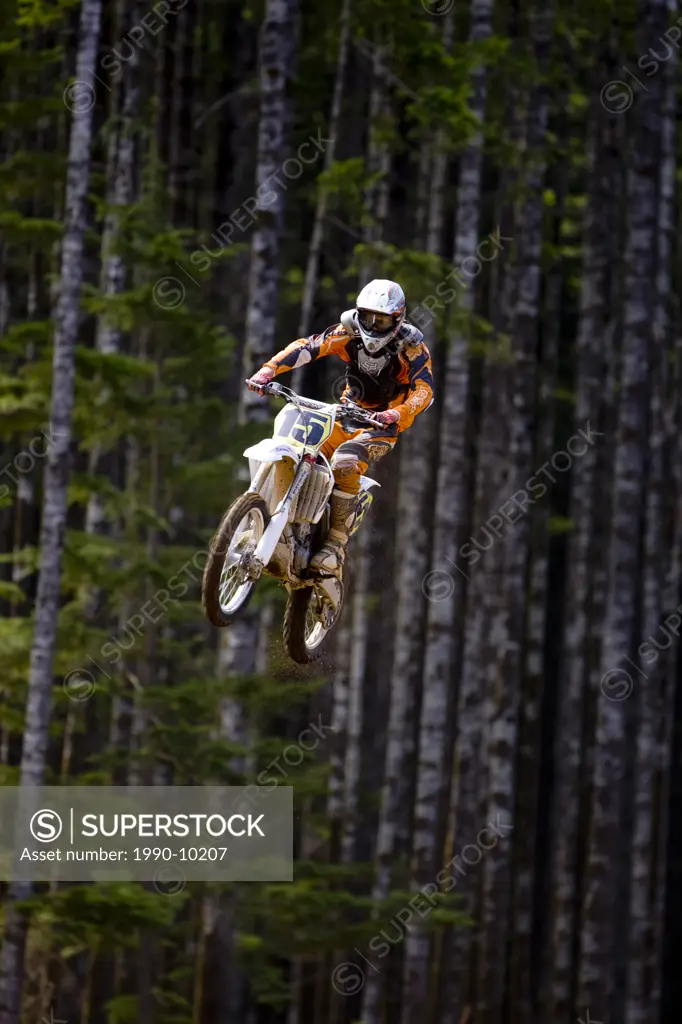 Motocross rider getting big air off of large double jump in motocross Race in Campbell River, Vancouver Island, British Columbia, Canada