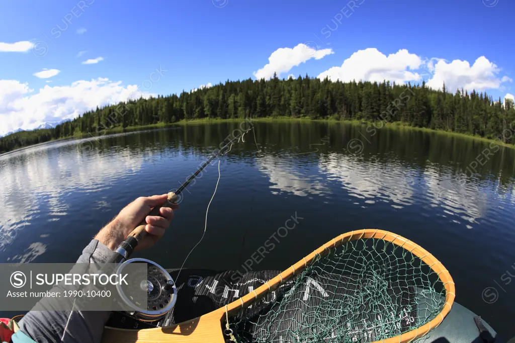 Trout fishing from float_tube, Duckbill Lake, Smithers, British Columbia, Canada.